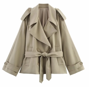 Detail of short double-breasted trench coat featuring classic lapels and adjustable cuffs