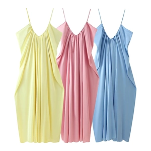 Detailed view of ruched satin slip dresses in yellow, pink and blue with V-neckline