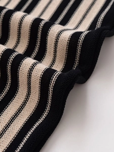 Macro shot of striped knit fabric detailing fine ribbed texture and soft elastic material