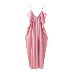 Detail of light pink satin slip dress with deep V-neck and elegant draped pleats