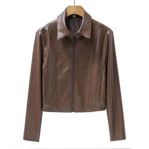 Close-up of brown faux leather jacket with metal zipper and fine texture detail
