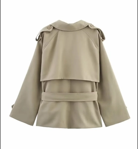 Back view of khaki cropped trench coat featuring classic storm flap and waist tie belt