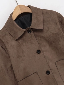 Deep brown faux suede biker jacket with classic lapel and black buttons on a wooden hanger