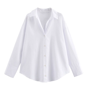 Detailed view of white long sleeve shirt featuring lapel collar and button-down front closure