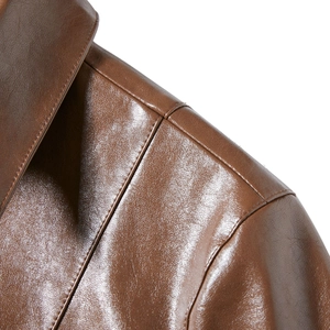 Detailed macro view showing the brown leather jacket shoulder with reinforced double stitching