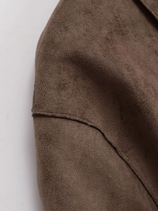Detail of shoulder seam on dark brown faux suede moto jacket showing stitching quality