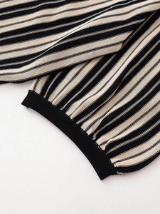 Detail of black and white striped knit fabric with high-quality ribbed cuffs and hem finishing