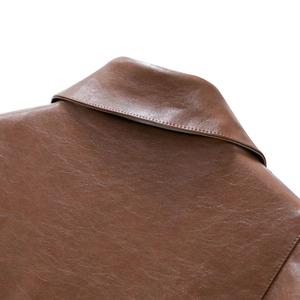 Close-up of lapel and stitching on high-quality brown PU leather jacket for women
