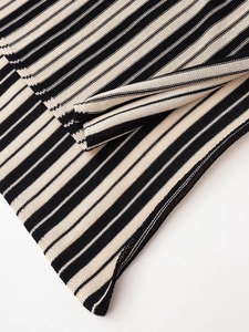 Macro shot of high-density striped knit fabric texture on a two-piece lounge set