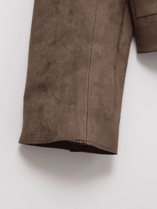 Close-up of deep brown faux suede jacket sleeve showing fine texture and stitching detail