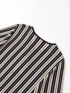 Macro shot of the round neckline and vertical black and white striped knit texture