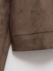 Detail shot of coffee brown faux suede biker jacket showing high-quality stitching on the hem