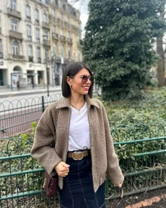 Close-up of brown sherpa jacket texture with lapel collar and stylish street fashion look