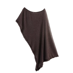 Close-up of metallic knit fabric showing the shimmering texture and draped wavy edge