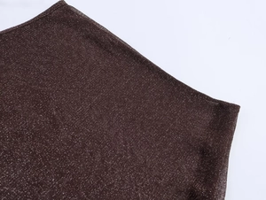 Macro detail of metallic brown fabric with fine shimmering lurex fibers and texture
