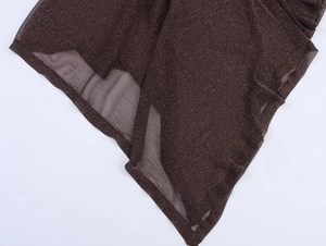 Detailed macro view of dark brown shimmering fabric with asymmetrical irregular edges