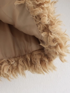 Vue macro de la texture fausse fourrure kaki et doublure en satin lisse