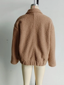 Rear view of brown faux shearling jacket showing turn-down collar and ribbed hem