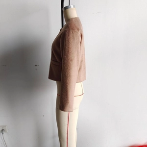Side view of faux wool jacket showing plush texture and light brown round neck design