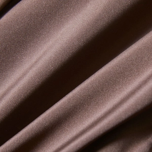 Detailed close-up of dark brown faux leather fabric with soft satin luster and smooth texture