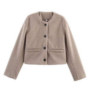 Detail view of round neck faux fur jacket showing pocket and soft textured fabric