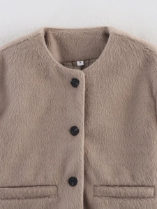 Detail view of the fuzzy camel faux wool jacket showing soft texture and black buttons