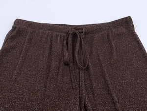 Detail of high waist wide leg pants showing metallic thread texture and elastic waistband