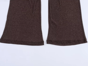 Detail of dark brown knit trousers with metallic glitter yarn and hem stitching