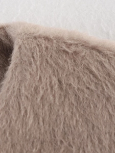 Close-up of soft camel plush fabric texture for the winter long sleeve jacket
