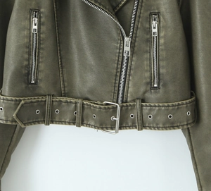 Detailed view of olive green PU leather jacket featuring vintage texture and silver zippers