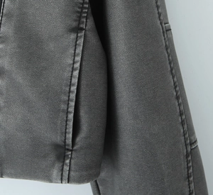 Detail der schwarzen Kunstlederjacke mit Seitentasche und langlebigen Doppelsteppnähten