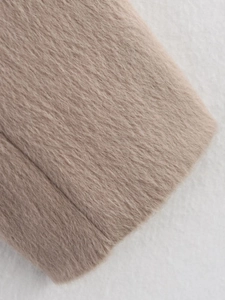 Macro shot of beige wool blend fabric texture showing soft brushed finish and neat seams