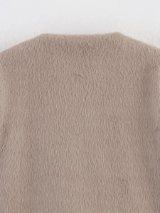Close-up of soft faux fur fabric on a light brown crewneck winter jacket for women