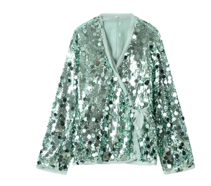 Detail of mint green sequin wrap top showing the shimmering fabric and waist tie belt