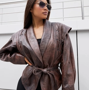 Detailansicht der braunen Vintage-Kunstlederjacke mit Flecht-Schulterdetails und Gürtel