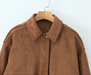 Detail of suede texture jacket showing shoulder straps and vintage metal buttons