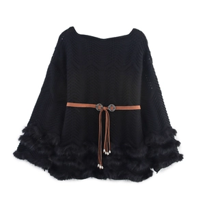 Detail of black knit shawl top with faux fur trim, brown belt and long leather tassels