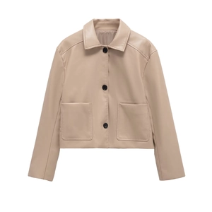 Detail of a beige short PU leather jacket with lapel collar and large flap pockets