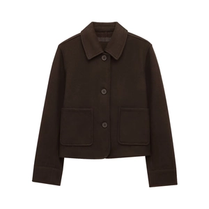 Detail view of deep brown short jacket featuring classic lapels and large square pockets