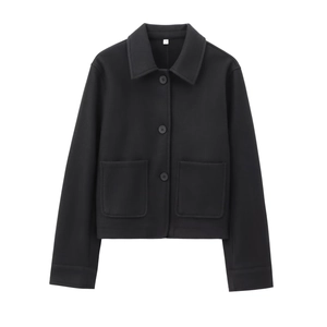 Detail of black wool blend short jacket featuring classic lapel collar and large pockets
