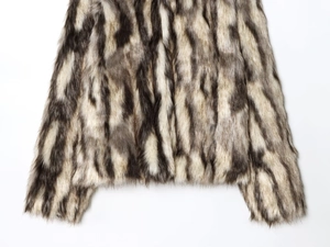 Detail of grey and white faux fur texture showing soft plush long-hair coat material