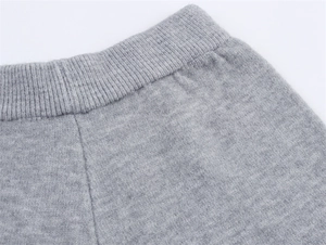 Detailansicht der grauen Strickhose mit geripptem Elastikbund und feinen Strickmaschen