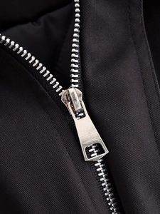 Close-up of silver metal zipper detail on black twill autumn jacket for women