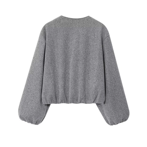 Detail view of the gray bomber jacket showing the textured fabric and elastic hem on the back