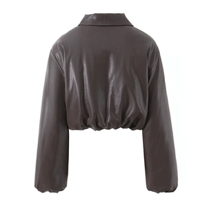 Detail of gathered elastic waist on brown faux leather jacket with high-quality texture
