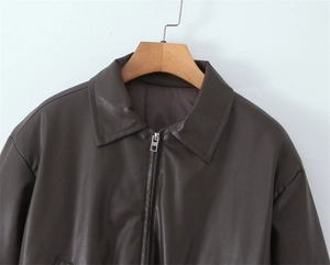Detailed view of dark brown faux leather jacket collar and silver metal zipper closure