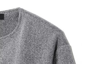 Detailed close-up of gray knit fabric texture and round neckline of a pilot jacket