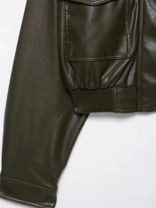 Detail of dark olive green leather jacket showing stitching and large pocket