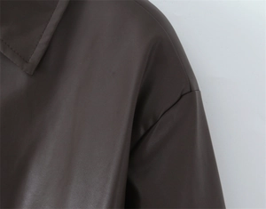 Detailed close-up of premium chocolate brown faux leather texture and reinforced stitching