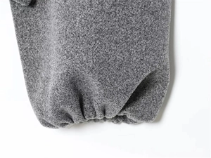 Close-up of grey blended fabric texture with elastic ribbed cuffs for windproof protection
